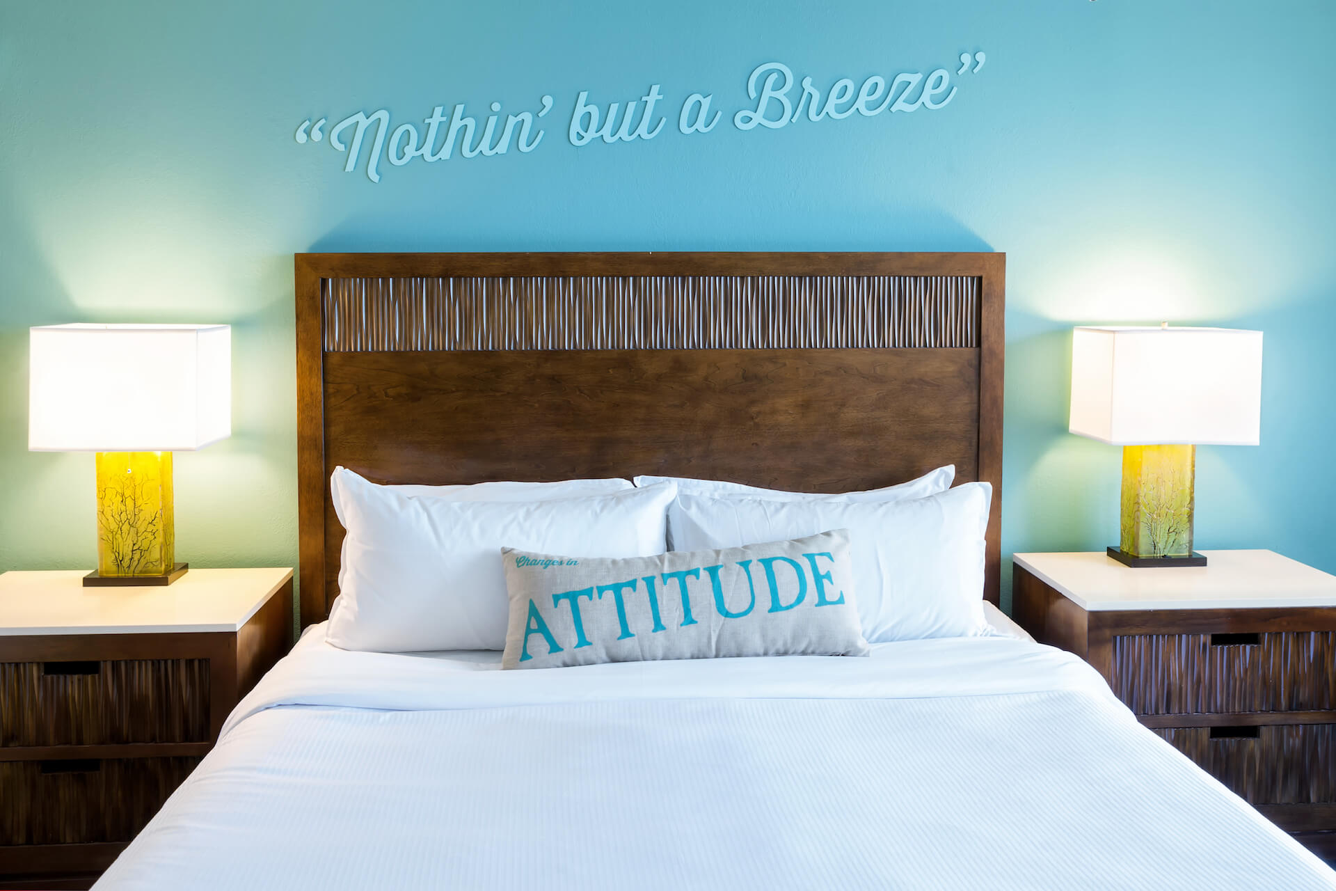 Bed with two end tables, lamps and pillow